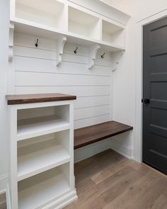 an instagram photo of a white mud room with shelving and shelves on the wall