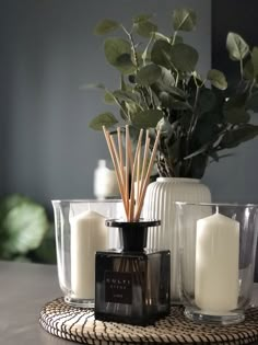 candles and vases are sitting on a table