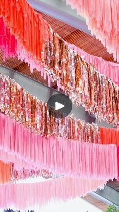 pink and orange streamers hanging from the ceiling