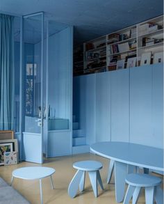 an instagram photo of a room with blue walls and furniture