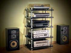 an array of electronic equipment sitting on top of a wooden floor next to a wall