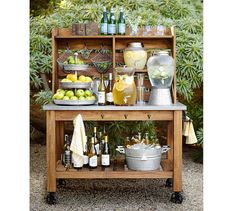 an outdoor bar cart filled with drinks and lemons