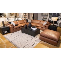 a living room filled with lots of brown furniture