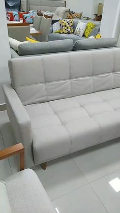 a white couch sitting on top of a hard wood floor