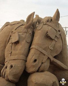 there are two horses made out of sand