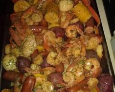 shrimp, potatoes and carrots are being cooked in a pan