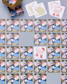 several cards with animals on them sitting next to each other and some wooden blocks in the background