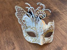 Created with the most elegant and gorgeous design with a beautiful butterfly on one side. The white and gold colors looks so elegant for anyone to wear on any events, Masquerade ball party, Carnivals, Mardi Gras, Halloween and more. This masquerade is lightweight and good quality material for long hours of comfortable wear, with black adjustable ribbon in the back. THE SIZE 6 inches tall and 6.5 inches wide. My shop www.etsy.com/shop/JVDesignAndEngraving JV Design & Engraving on Instagram. Elegant Gold Masquerade Mask As Gift, Elegant White Masquerade Mask For Mardi Gras, Elegant White Masquerade Mask For Carnival, White Formal Masquerade Mask For Carnival, White Masquerade Mask For Mardi Gras, Elegant White Wedding Masquerade Mask, Elegant White Masquerade Mask For Weddings, White Masquerade Mask For Mardi Gras Gift, White Venetian Masquerade Mask For Mardi Gras