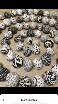 there are many different types of beads on the table, including one with black and white designs