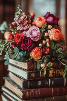 a stack of books filled with lots of different colored flowers on top of each other