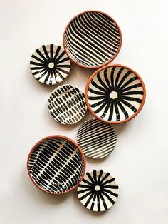 four black and white bowls sitting next to each other