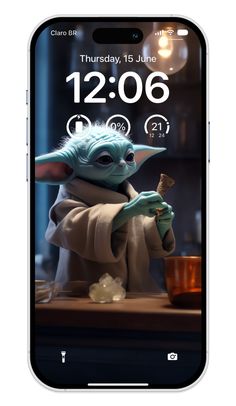 an iphone with the star wars theme on it, showing baby yoda holding a wand