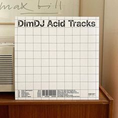 a piece of paper with the words dimd - acid tracks written on it next to a radio