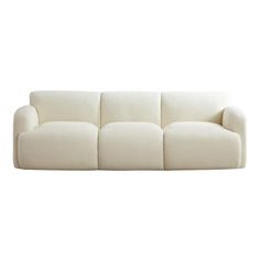 a white couch sitting on top of a white floor