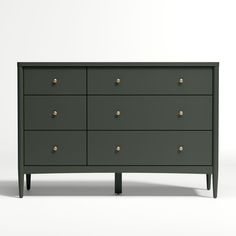 the chest of drawers is painted green and has brass knobs on each drawer,