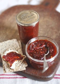 there is a jar of jam and crackers on the table