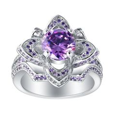 The Violet statement ring from the distinguished Ginger Lyne Collection is a true testament to unmatched elegance and intricate craftsmanship. Drawing inspiration from the poetic beauty of flowers. Violet statement ring from the distinguished Ginger Lyne Collection is a true testament to unmatched elegance and intricate craftsmanship. Drawing inspiration from the poetic beauty of flowers, this piece showcases a breathtaking design that elegantly blossoms with a vivid purple cubic zirconia stone Exquisite Silver Amethyst Ring For Wedding, Elegant Purple Flower Ring, Elegant Purple Gemstone Flower Ring, Silver Flower-shaped Promise Ring, Flower Shaped Ring With Accent Stones For Anniversary, Flower Shaped Wedding Ring With Accent Stones, Purple Flower Ring For Anniversary, Elegant Purple Flower Wedding Ring, Purple Flower-shaped Jewelry For Weddings