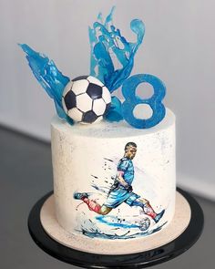 a birthday cake decorated with an image of a soccer player and the number eight on it