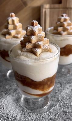 three desserts in small glass dishes on a table