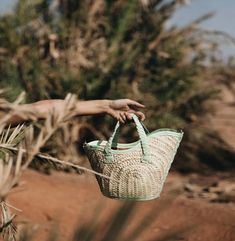 Handmade woven basket bags with braided leather short handles and an adjustable leather strap to wear over the shoulder or cross body. Handcrafted in Morocco, within a cooperative of Berber women, using basketry techniques passed down for generations. By supporting their crafts, we help these women achieve financial independence so that they become totally self-sufficient. Dimensions: XSmall Bag: 7.5" Height (Measured from the highest point of the bag) 5" Width (measured at bottom of the bag) Medium Bag: 9" Height (measured from highest point of the bag) 7" wide (measure at the bottom of the bag) Large Bag: 10" Height (measured from highest point of the bag) 10" Width (measure at the bottom of the bag) Materials: Main component palm and raffia,  Trim and handle are made from 100% leather Woven Leather Bucket Bag For Market, Summer Straw Bag With Woven Leather And Round Handle, Woven Leather Palm Leaf Straw Bucket Bag, Woven Leather Basket Bucket Bag, Artisan Bucket Bag With Braided Handles In Natural Color, Artisan Straw Bucket Bag With Leather Handles, Artisan Natural Bucket Bag With Braided Handles, Woven Leather Basket Straw Bag, Woven Leather Basket Straw Bag For Market