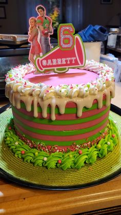 a birthday cake is decorated with icing and sprinkles on a table