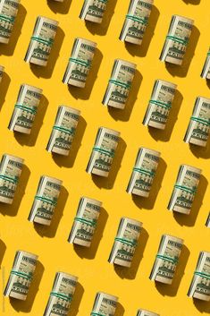 several stacks of one hundred dollar bills arranged in rows on a yellow background by luma studio for stocks & bonds