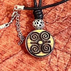 This unique native necklace features a engraved wood 1 inch pendant with a metal bezel and bead. inspired by symbols of the Cherokee Nation. The pendant hangs from a 21 inch black cord. Metal cord ends and lobster clasp with 2 inch extension chain. The necklace is perfect for adding a touch of bohemian style to any outfit, and is made with quality materials sourced from the United States. Whether you're dressing up for a special occasion or just adding some flair to your everyday look, this pendant necklace is sure to be a standout piece in your collection....sustainable and eco friendly.. Note; wood grain and tint may differ. Cherokee Symbols, Symbol For Strength, Native Necklace, Engraved Metal, Symbols Of Strength, Cord Ends, Metal Engraving, Bezel Pendant, Engraved Wood