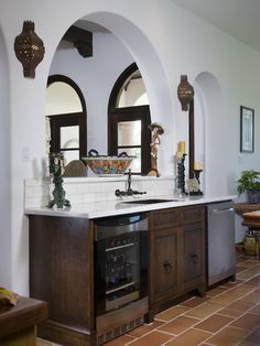 a kitchen with an oven, sink and wine cooler in it's center island