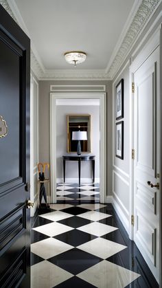 an empty hallway with black and white checkered flooring