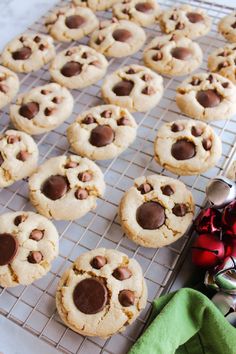 chocolate chip cookies cooling on a wire rack next to christmas decorations and other holiday items