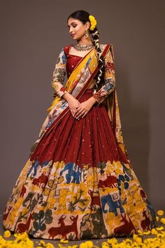 Maroon base attached cancan lehenga with elephant and deer kalamkari hand painted patterns and embroidery. Paired with padded peach blouse embroidered with glass beads and yellow printed dupatta with contrast lace border. - Aza Fashions Peach And Maroon Outfit, Unstitched Anarkali Set With Kalamkari Print For Wedding, Kalamkari Print Anarkali Set For Wedding, Floor-length Kalamkari Anarkali Set For Wedding, Red Kalamkari Print Choli For Wedding, Festive Anarkali Set With Kalamkari Print For Wedding, Anarkali Dupatta With Kalamkari Print For Wedding, Festive Kalamkari Anarkali Set For Wedding, Wedding Kalamkari Print Dupatta