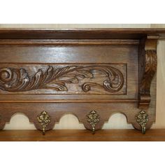 a wooden shelf with ornate carvings on it