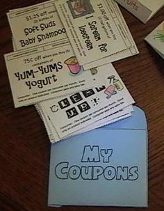 four coupons sitting on top of a wooden table next to an envelope with the words my coupons