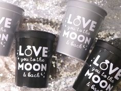 three cups with love you to the moon and back printed on them sitting next to each other