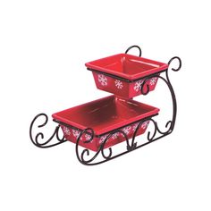 two red serving trays sitting on top of each other, one with an ornate design