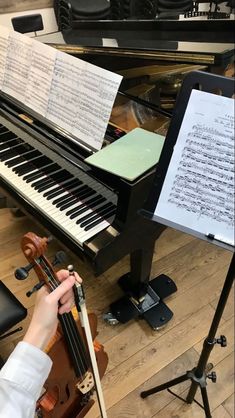 a person playing an instrument in front of a piano