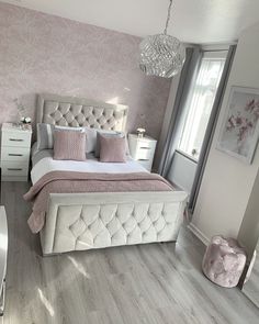 a bedroom with pink and white decor in the middle of it, including a large bed