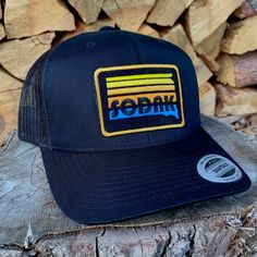 This sharp black SoDak Sunset trucker hat will be your new favorite! Great hat for any South Dakota adventure or just chilling and watching SoDak sunsets! The black snapback cap features my original SoDak Sunset patch, embroidered in bright colors on the front of the hat, with mesh in the back and an adjustable snapback closure. This hat will look great on guys and girls, one size fits most. Looking for a flat bill with this design? Go here: Visit my Oh Geez! Design shop home here: www.etsy.com/ Retro Black Trucker Hat For Sports, Retro Black Baseball Cap With Flat Bill, Retro Black Trucker Hat For Streetwear, Retro Black Snapback Hat For Sports, Retro Black Flat Bill Baseball Cap, Black Flat Bill Dad Hat For Outdoor, Black Retro Sports Baseball Cap, Retro Black Snapback Baseball Cap, Retro Black Snapback Cap