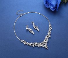 A classy bridal necklace and earrings set, perfect for the romantic bride! Adorned with iridescent pearls and clear crystals that capture the light from every angle sparkling beautifully, the pieces are rhodium plated for a flawless finish which enhances the intricate detailing and conveys a modern take on old elegance. Necklace: 16" long (approx. 41cm) with a 2.5" extension chain (approx. 6.5cm) which allows the length to be adjusted to 18.5" (approx. 47.5cm). If you would like it longer, pleas Elegant Silver Pearl Jewelry Sets, Formal Silver Pearl Jewelry Sets, Silver Pearl Necklace With Rhinestones For Wedding, Silver Crystal Jewelry Set With Pearl Drop, Formal Silver Pearl Rhinestone Necklace, Formal Silver Rhinestone Pearl Necklace, Formal Silver Rhinestone Necklace With Pearls, Silver Pearl Rhinestone Necklace For Formal Occasions, Elegant Silver Rhinestone And Pearl Necklace