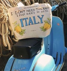 a blue scooter with a sign on it sitting next to ropes and rope