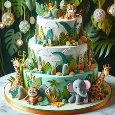 a three tiered cake decorated with animals and plants