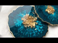 two blue plates with gold decorations on them