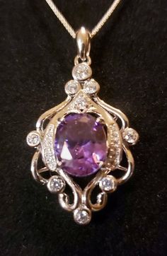 "Beautiful Purple Alexandrite Color Changing From Purple To Magenta Lab Grown Stone 8x10mm In Vintage Style Rococo Sterling Silver Chandelier Design Necklace. 18-20\" Sterling Chain." Formal Pendant Jewelry With Accent Stones, Oval Pendant Jewelry With Accent Stones For Gift, Sterling Silver Pendant For Formal Occasions, Elegant Gemstones With Accent Stones For Gift, Formal Sterling Silver Pendant, Elegant Gemstones With Accent Stones As Gift, Silver Necklaces With Accent Stones For Gifts, Silver Diamond Gemstones For Gift, Exquisite Gemstones With Accent Stones As Gifts