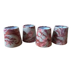 three lampshades with pink and white designs on them