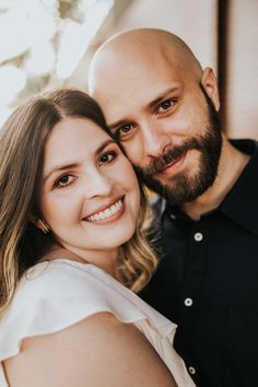 a man and woman are smiling for the camera while they pose for a photo together