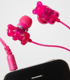 the pink ear buds are connected to an iphone