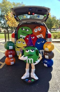 the trunk of a car is decorated with m & m's and other characters