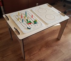 two trays with candles on them sitting on top of a table in the middle of a room