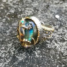 "WELCOME TO MY WORLD \"BALI SILVER SUN\" ! Salamander Sterling Silver Ring. Gilding and Rhodium plating. Stone Labradorite. Eyes Green Emeralds The total weight of the ring is 13 grams. Size For America / Kanada 7 - 1 / 2. The inside diameter is 17.5 millimeters. Eyes of emerald, Diameter of 1.5 millimeters. Oval stone Lambrodarite 16 X 13 millimeters The cap of the ring, the height considering the Salamander is 20 millimeters. The Ring is Adjustable - Free size. Includes branded packaging. \"Si Nature-inspired Cabochon Jewelry For Anniversary, Unique Silver Jewelry With Accent Stones, Nature-inspired Cabochon Ring Jewelry, Nature-inspired Cabochon Ring, Silver Labradorite Jewelry For Wedding, Sterling Silver Fusion Jewelry With Accent Stones, Handmade Labradorite Jewelry For Wedding, Handmade Labradorite Wedding Jewelry, Green Labradorite Ring