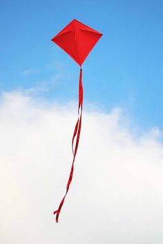 a red kite flying high in the sky